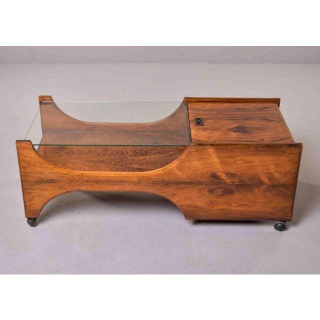 This sculptural Italian coffee table is constructed in rosewood with strong figured grain, its case formed as two...