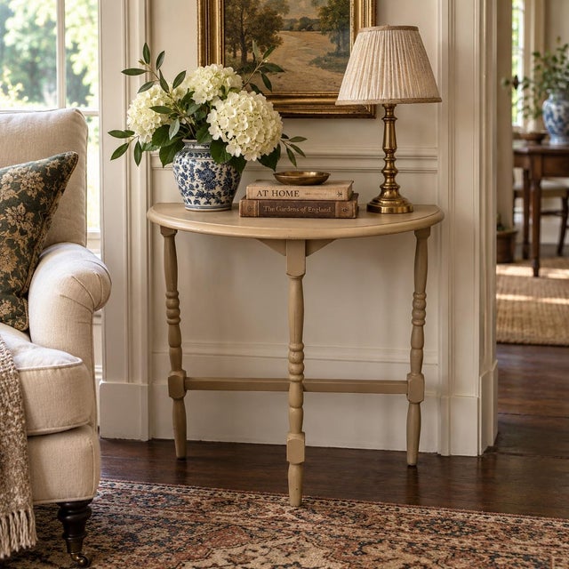 A handsome Federal side table crafted in walnut and painted in a light brown. The elegant turned legs create a piece that...