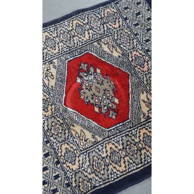 We offer this hand-knotted decorative rug/tablecloth with a delicate pattern in dark blue and red colors, measuring...