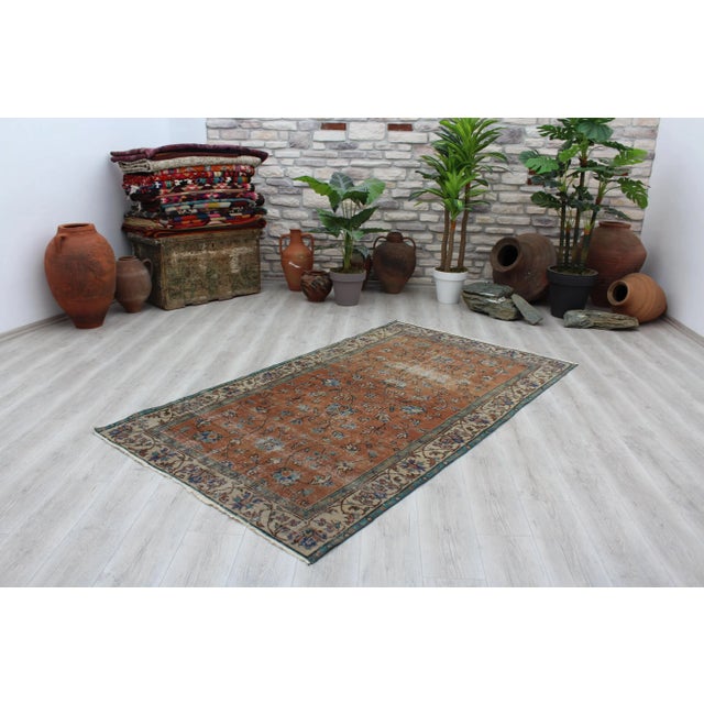 This gorgeous hand knotted Vintage Turkish Anatolian area rug is approximately 60 years old in excellent vintage...