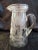 Beautiful mid-century crystal handled pitcher featuring deeply etched design of delicate leaves and carnations around...