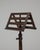 1900s French wooden music stand featuring a finely crafted adjustable frame and tripod base. Made from richly toned wood,...