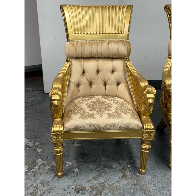 Design Plus Gallery presents a Pair of Opulent Lion Head + Winged Arm Chairs from Homey Design. A distinctive classic...