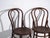 This pair of antique bentwood chairs in the thonet style in steamed beech, with loop back and round seat, reproduces the...