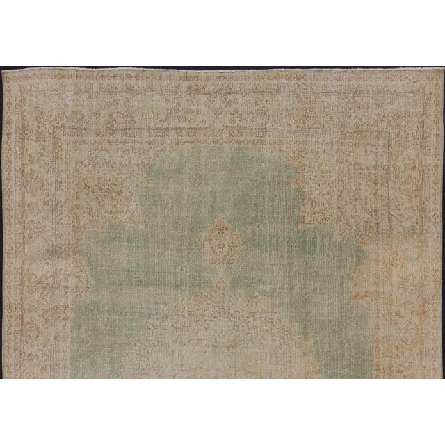 Measures: 8'9 x 12'5. Keivan Woven Arts / Unique Turkish distressed rug with muted colors in taupe, light green, beige....