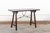 A Spanish wooden travel table, with forged iron stretcher, from the 19th century. This antique table from Spain was...