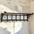 A charming marriage of Dutch ceramic art and hand-forged ironwork, this 19th century wall-mounted coat rack features six...