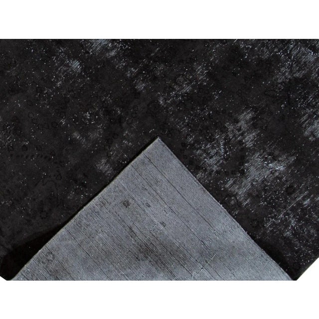 Beautiful hand-knotted vintage wool rug with a charcoal field. This distressed rug has gray accents featuring an all-over...