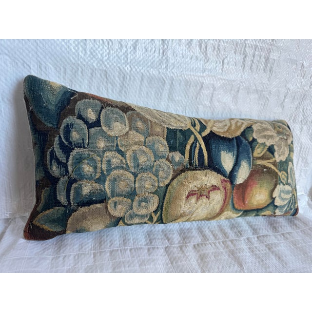 A beautiful sixteenth century Brussels tapestry fragment depicting fruit and foliage in a richly aged palette of deep...