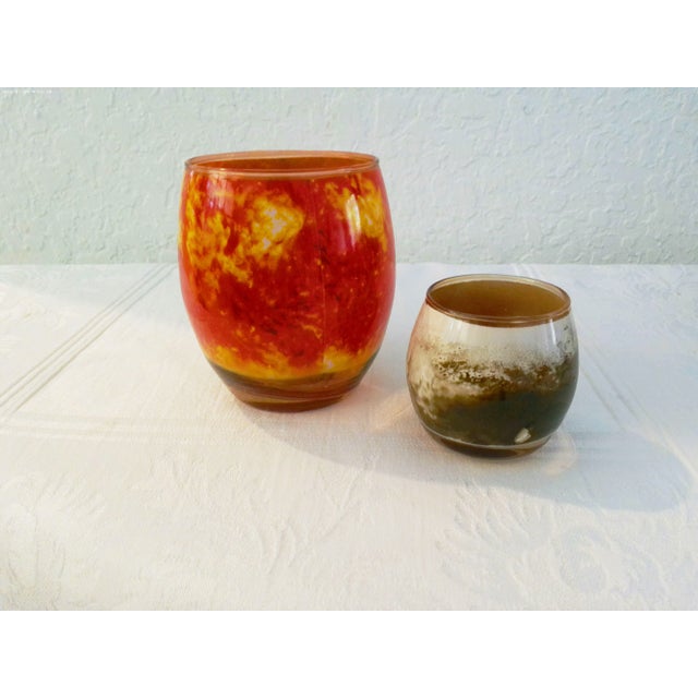 Colorful set of eight glass votive candles holders each representing a planet in the Solar System: Sun, Uranus, Mars,...