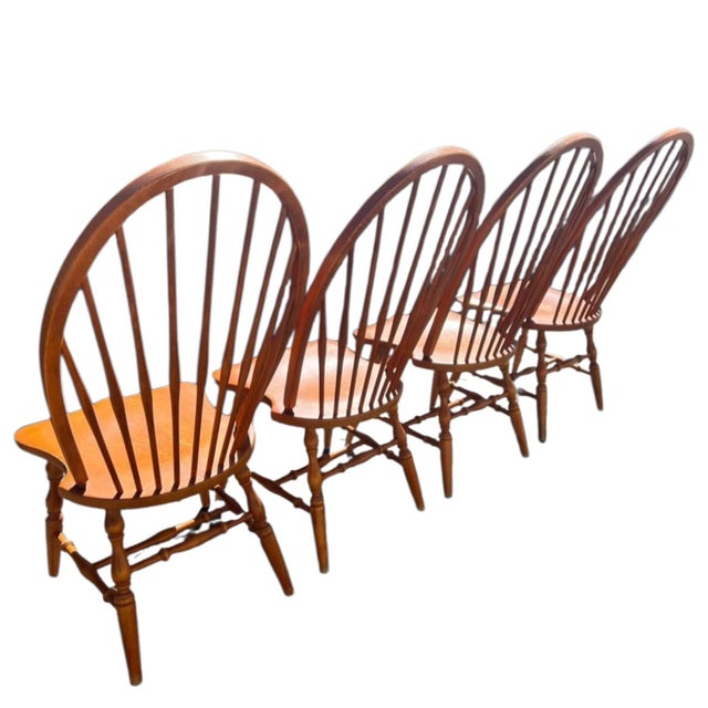 Set of 4 Vintage Bow-Back Windsor Dining Chairs Add a touch of timeless, rustic warmth to your home with this beautiful...