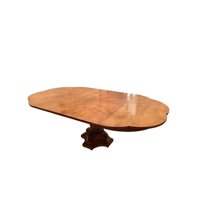 An exceptional 1950s dining table by Knapp & Tubbs, showcasing the rich character and dramatic figuring of burlwood....