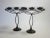 An imposing matched pair of three-armed candle holders hand forged in black iron during the Arts and Crafts period in...