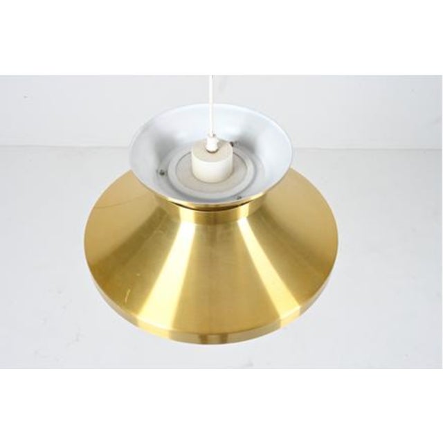 This brass pendant designed by Carl Thorne was produced for Granhaga Metallindustri in Sweden. The shade is solid brass....