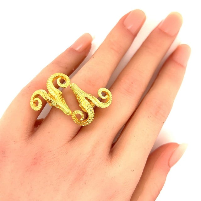 This striking double rams head ring is finely crafted from solid 18k yellow gold and designed with a bold, symbolic...