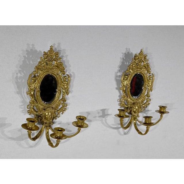 Pair of wall lights with three arms of lights, finely chiseled and worked, in gilded bronze, dating from the middle of the...