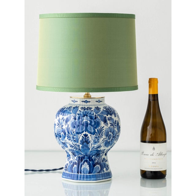 Hand-painted Dutch Delftware Chinoiserie lamp dated 1971, featuring a classic blue-and-white ginger jar base with a...
