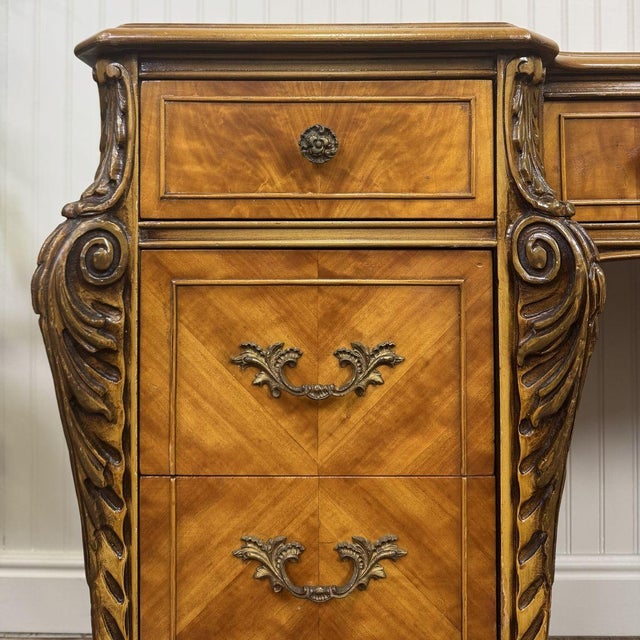 Vintage French Provincial desk or vanity with diamond-matched veneer and Louis XV-l–style carving. This piece features a...