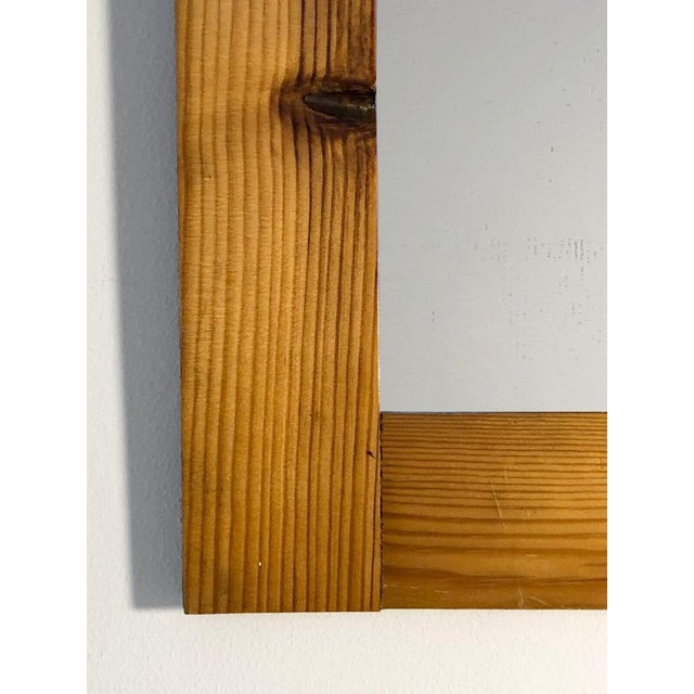 A small rectangular mirror, modernist, constructivist, bauhaus, with a frame made of 4 pine strips nested within each...