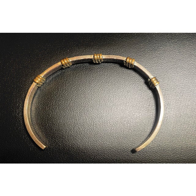 Native American Navajo artist R. Wilson, two piece bracelet and earrings set. The open cuff bracelet is composed of...