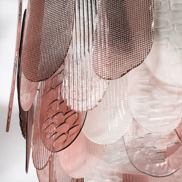 This sculptural Modernist Round 3-Tier Hand-Blown Murano Glass Chandelier w/ Oval Reeded Shades originated in Italy, 21st...