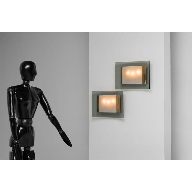 This is for an exquisite pair of model 2213 wall lamps designed by the legendary max ingrand for fontana arte around 1960....