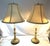 Timeless pair of French Art Nouveau candlestick lamps from the early 20th century. They're made of embossed brass with...