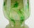 A highly decorative glass vase by Erwin Eisch / Glashütte Eisch. Several shades of green, clear glass at the rim. Marked...