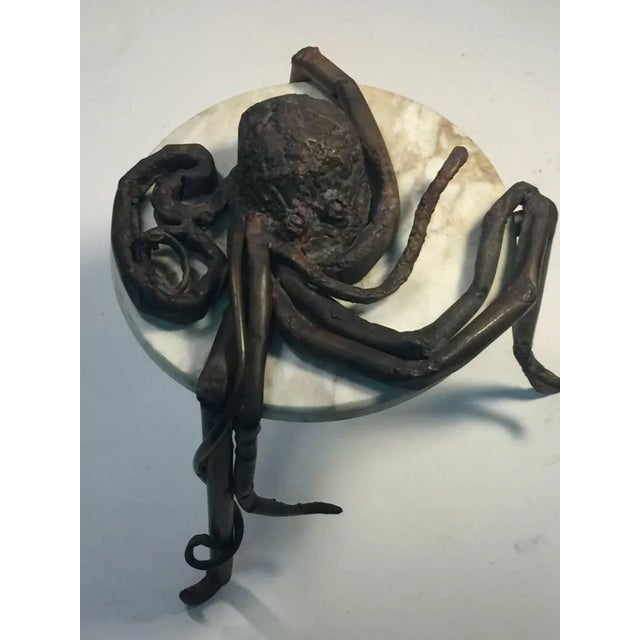 Unusual Hand Sculpted and Forged Brutalist Metal Octopus Draped Upon A Round Tan Marble Top Table. Both a Realistic...