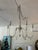 This transitional showstopping chandelier gathers inspiration from antique style fixtures with a turned wood center...
