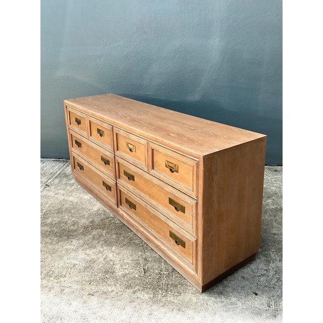 This vintage Stanley campaign dresser showcases a refined, honey-toned oak veneer with beautiful, consistent grain...