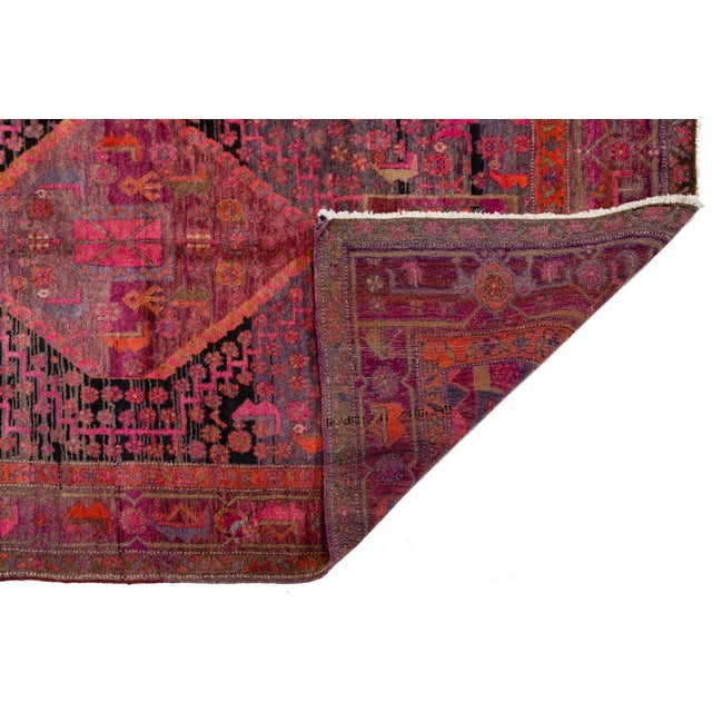 Hand-knotted Shiraz wool rug featuring three bold diamond medallions on a richly patterned red field. Accented with...