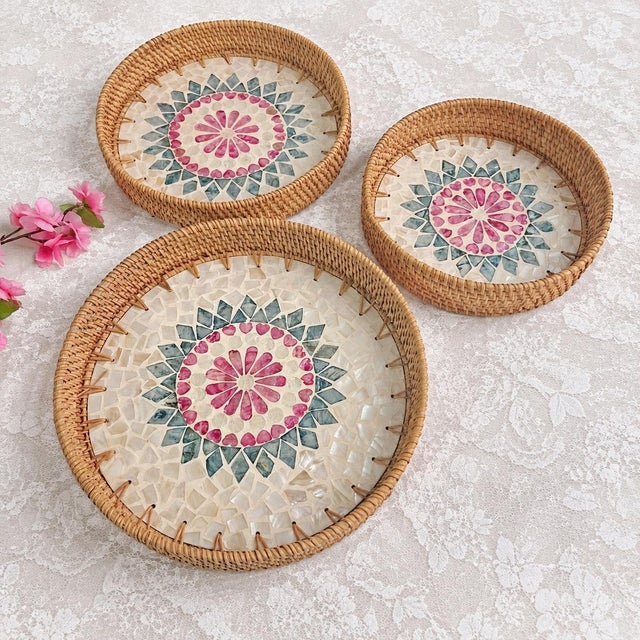 This set of three nested trays is hand-woven by Vietnamese craftsmen. The basket is woven with natural rattan and the...