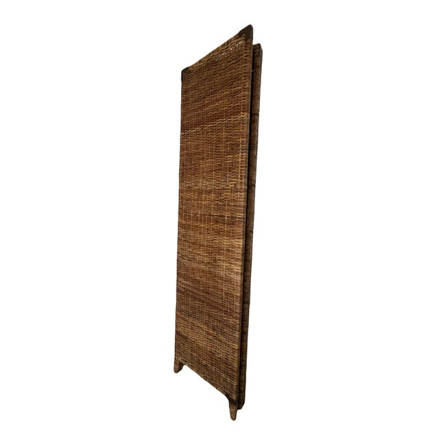 Vintage Rattan 3 Panel Folding Screen or Room Divider. The screen features three folding reinforced panels with aged...