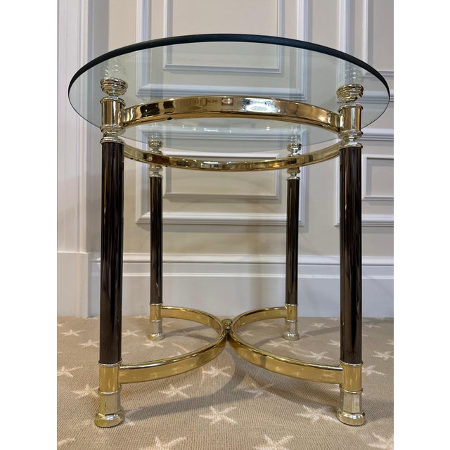 Vintage Hollywood Regency Modern brass and glass Table. Good vintage condition There is no signature or mark on this...