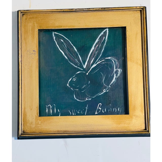 Abstract mixed media by Elia Moon Bunnies series , on brown recycled paperboard, framed in wide gold frame.