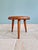 Modernist tripod stool in solid wood, made in the 1950s-60s. It features a thick, circular seat with rounded edges,...