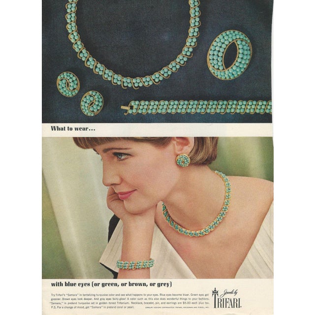 1964 oval goldtone studded with cabochon faux-turquoise clip earrings. Marked crown "TRIFARI©" on the clips. Measure:1...