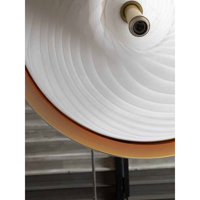 An Italian Murano glass white colored campanula shaped light fixture from the Midcentury period, with single socket and...