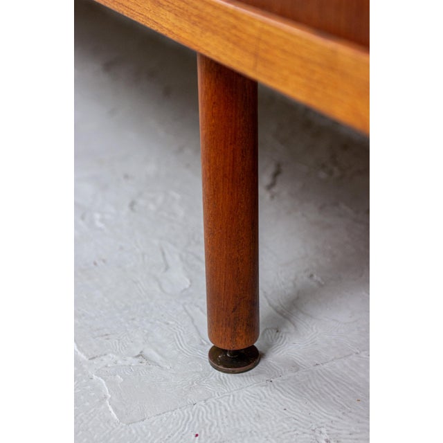 This sideboard, designed by Ejner Larsen and Aksel Bender Madsen, was manufactured by Næstved Møbelfabrik in Denmark....