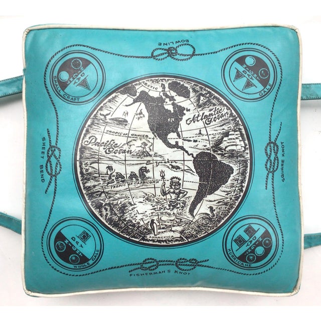 Mid-century vinyl boat cushion with globe in center surrounded by boating knots and signal flag graphics, manufactured by...