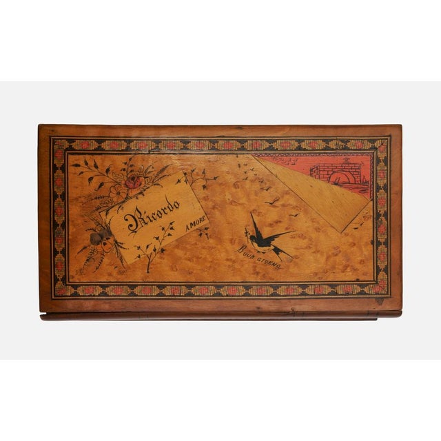 Book-shaped casket, Italy, circa 1900. Stained walnut with elaborate illusionistic inlays on the lid, which is also...