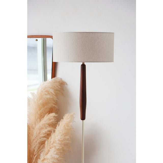A vintage teak and brass floor lamp with a scandinavian design this vintage teak and brass floor lamp embodies the...