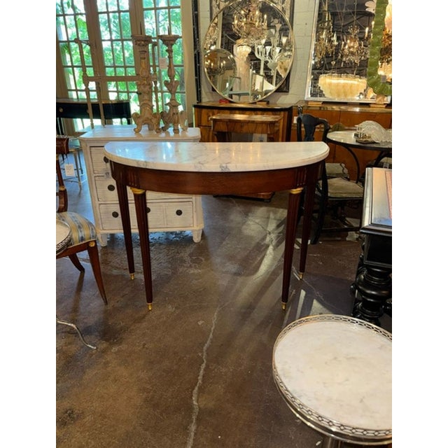 French Louis XVI Style Mahogany Console. A French Louis XVI–style mahogany console is one of those pieces that instantly...