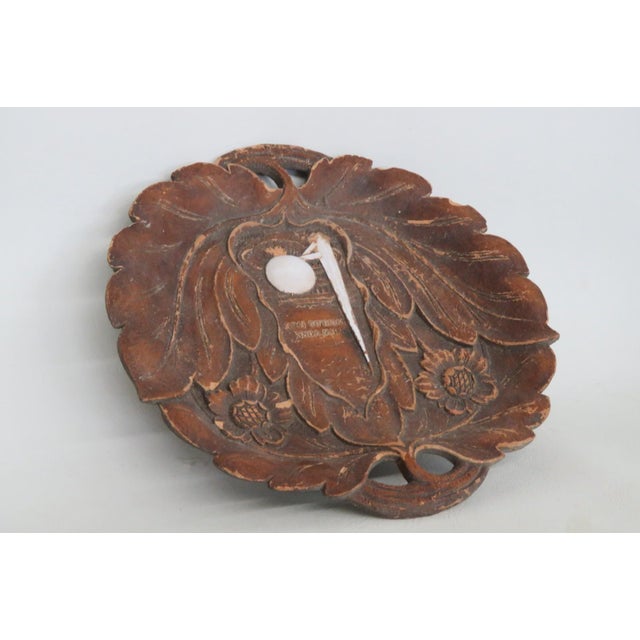 This Decorative Plate is made out of Syroco wood. This lovely souvenir plate features a rounded petal edge shape with...