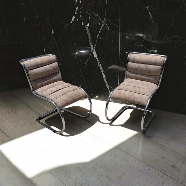 Striking pair of vintage Italian Modern cantilever lounge chairs featuring sleek polished tubular chrome frames and...