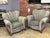 Pair of vintage to be reupholstered armchairs featuring sculpted scalloped backrests, rolled arms with wood accents, and...