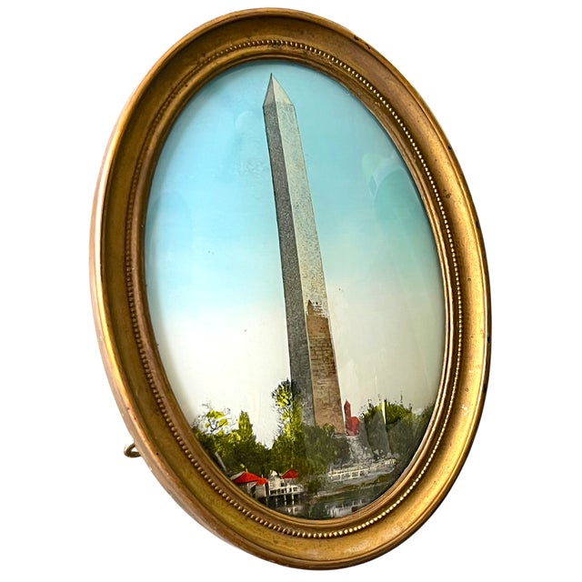 A charming turn-of-the-century reverse-painted glass depiction of the Washington Monument, housed in its original oval...