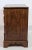 A handsome pair of English oak bedside chests dating to the early 20th century, offering timeless craftsmanship and...