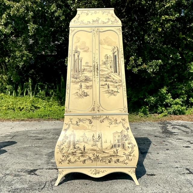 Infuse your space with eclectic charm through this vintage boho painted Grand Tour cabinet. Adorned with artistic, hand-...